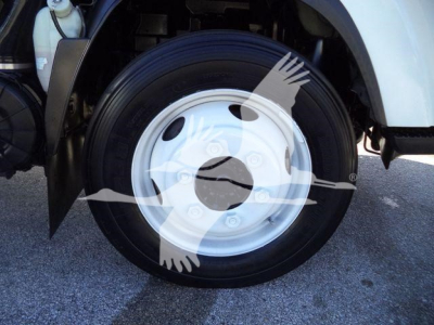 Isuzu NPR HD wheel and tire assembly in-view showing steel rim and tire with fender nearby.