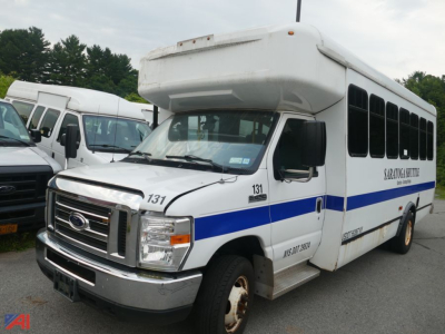 Ford Econoline E450 bus with wheelchair lift, front view showing blue stripe and side windows.