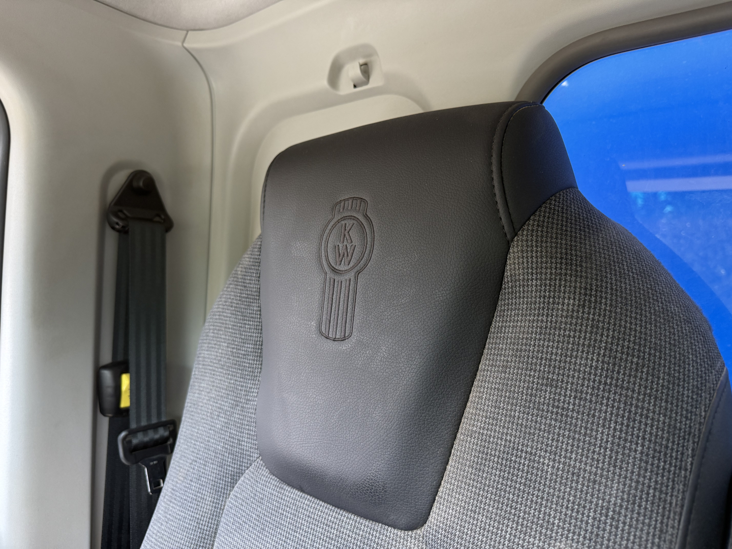 Kenworth T880S truck cabin seat with KW emblem visible.