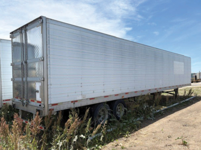 Trailer side view showing a 2005 Utility 3000R refrigerated trailer with aluminum siding, triple axle wheels, and rear doors.