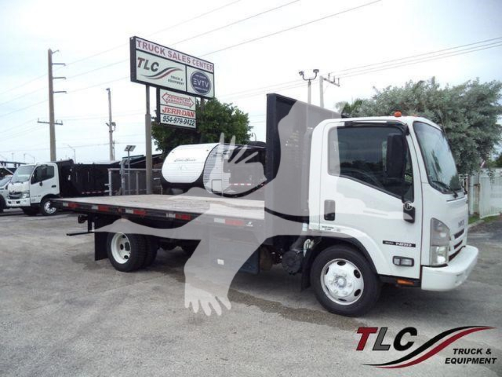 Isuzu NPR flatbed tow truck type showing cab, flatbed bed, and equipment; TLC Truck Sales Center logo overlaid on image.