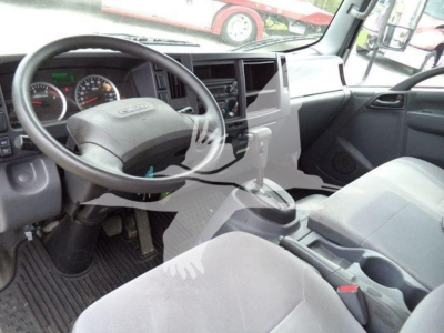 Isuzu NPR/Nrr interior showing steering wheel, dashboard gauges, center console, gear shift, and front seats.