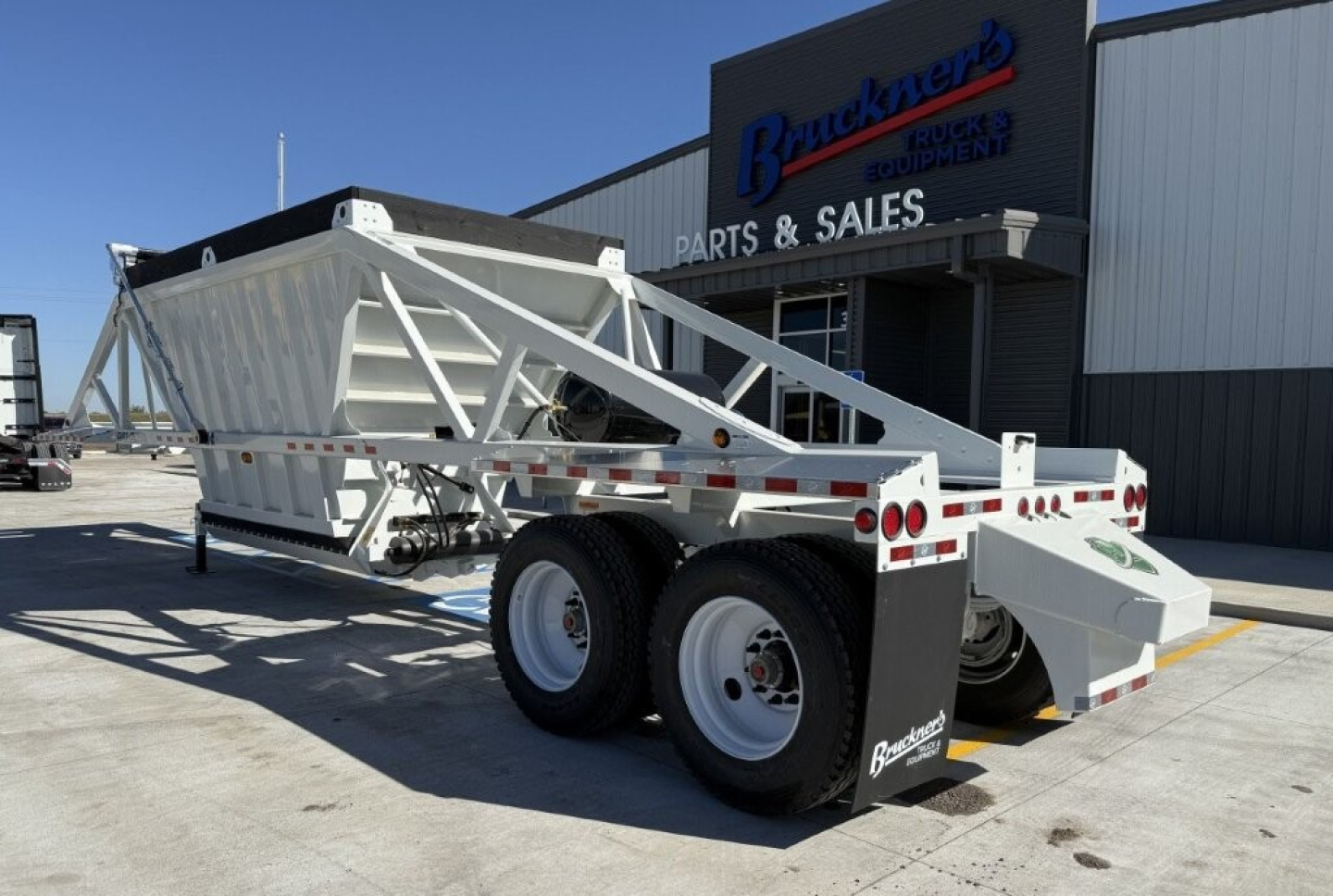 Trailer in-service showing Armor Lite SBD40 dump trailer with dual rear axles and white finish.