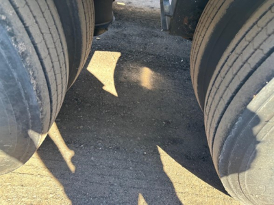 Lowboy trailer wheels showing dual tires and a gap between axles.
