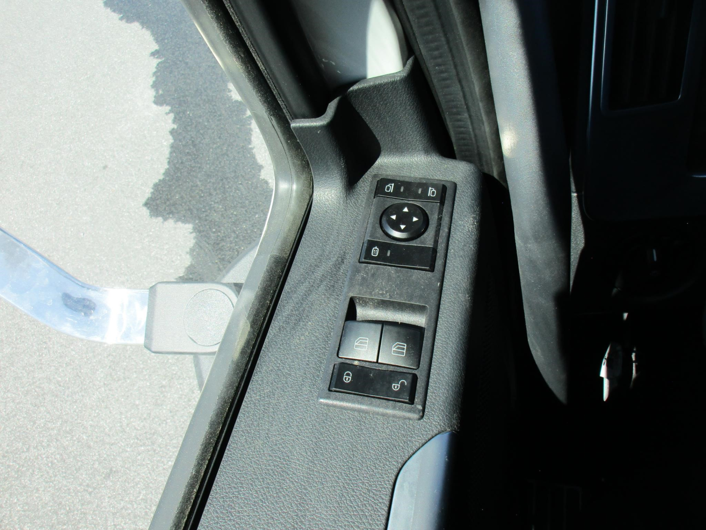 Truck interior door panel with window/mirror control switches visible.