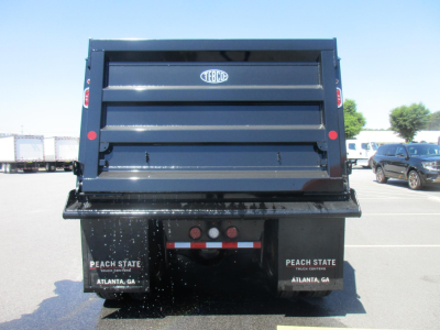 Dump truck bed showing TEBCO logo on tailgate and Peach State license area in Atlanta, GA.