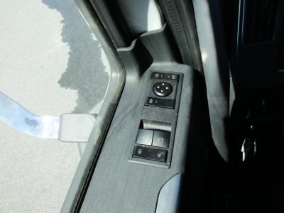 Truck interior door panel with window/mirror control switches visible.