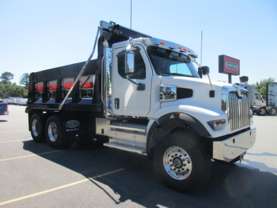 Dump truck with white cab and black dump body, side view showing Western Star 47X. VIN plate visible? Stock number 342925 not legible. Side steps and chrome bumper visible.