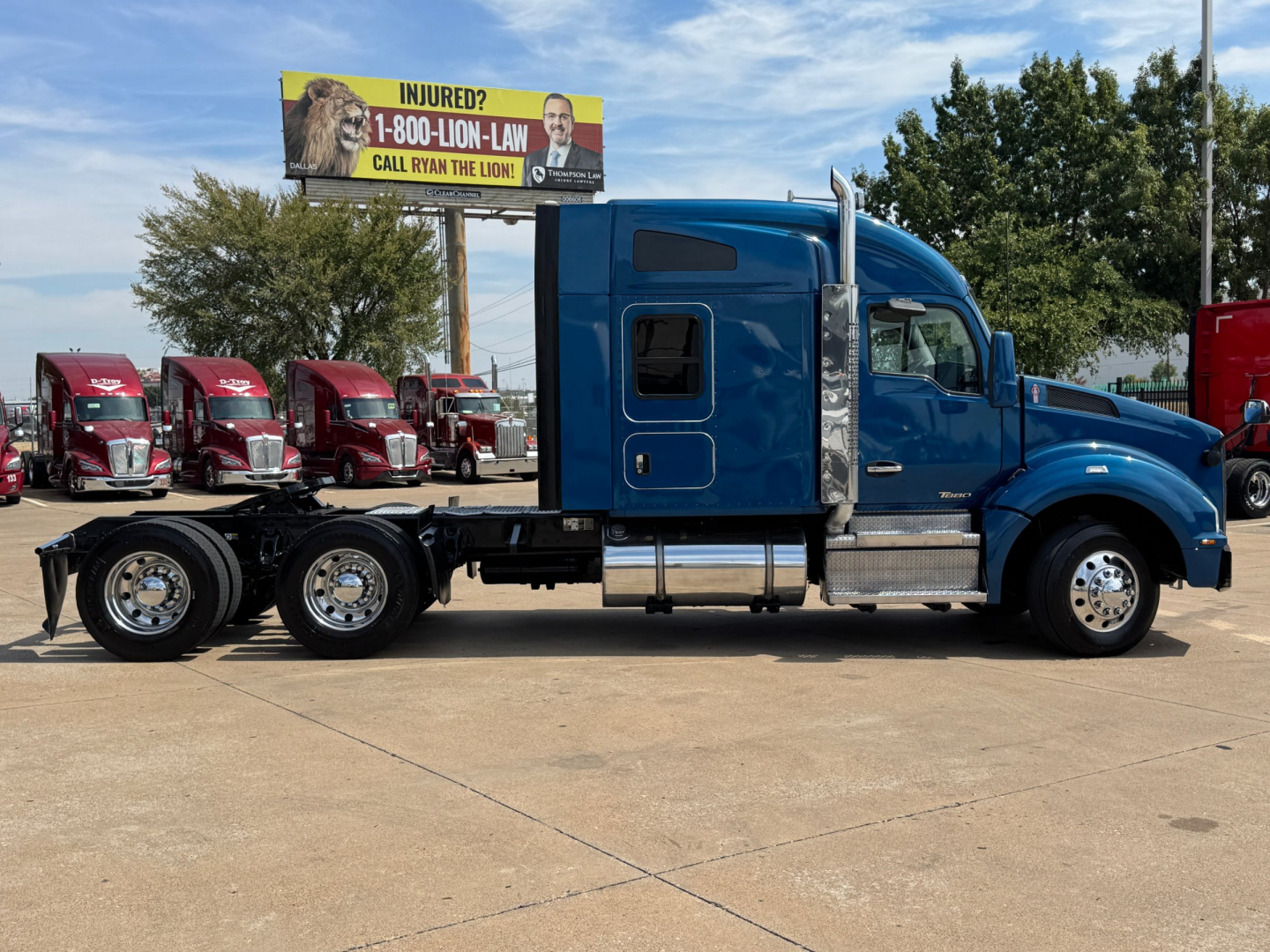 Kenworth T880 conventional sleeper truck side view showing blue cab, extended chassis, dual rear axles, chrome fuel tanks, and wheels.
