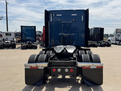 Kenworth T880 rear view showing dual rear axles and fifth-wheel attachment area with mud flaps and rear bumper.