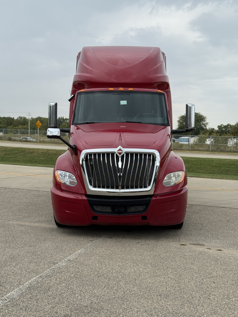 Truck front view of a red 2018 International LT625 sleeper cab with chrome grille and large side mirrors.