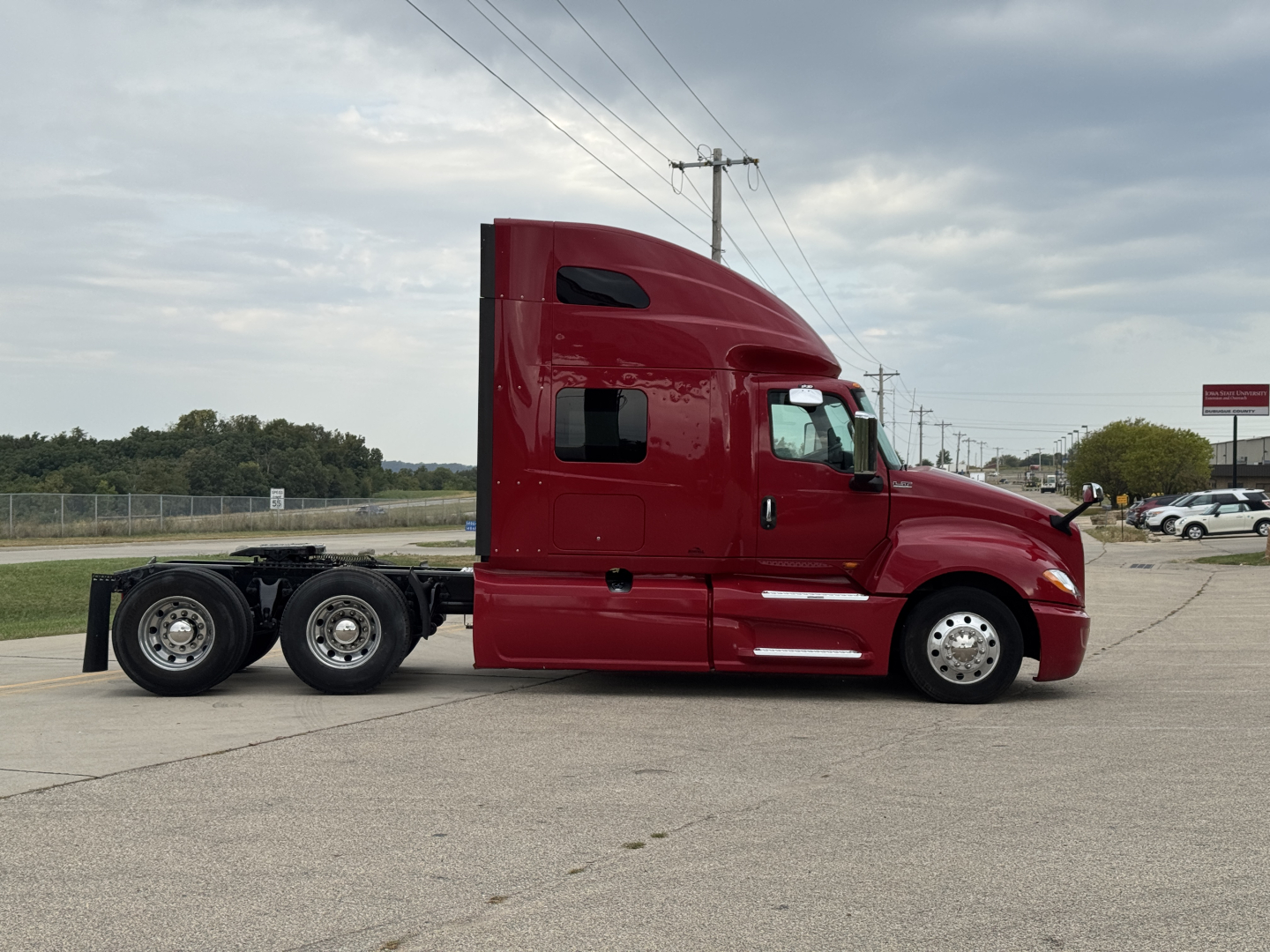 2018 International LT625 sleeper cab truck side view showing long wheelbase, dual rear axles, maroon exterior, VIN sticker not visible