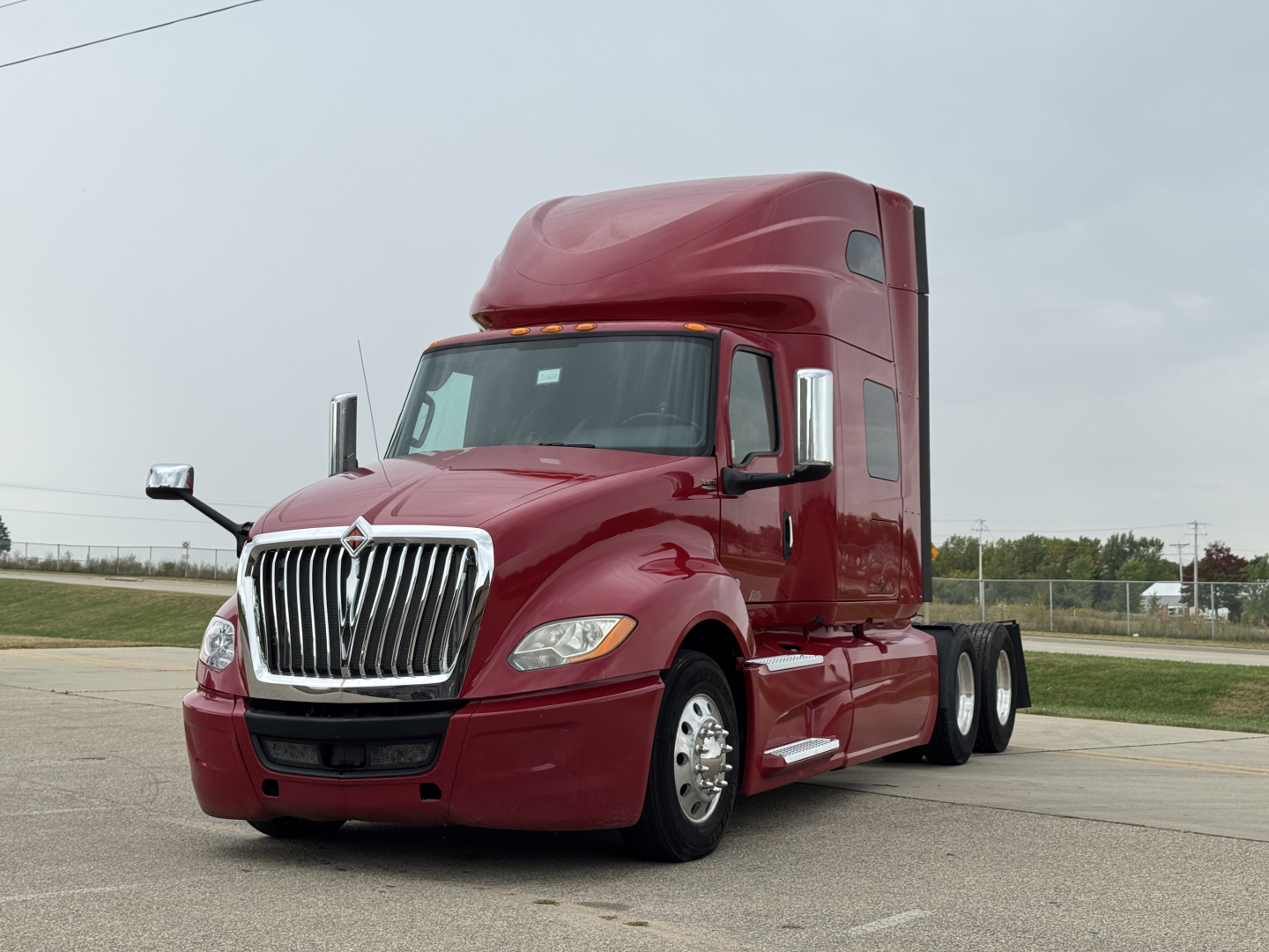 Truck cab and sleeper unit showing International LT625 with maroon paint and chrome grille