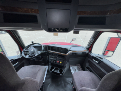 Interior of a 2018 International LT625 truck cabin with steering wheel, dashboard, and driver and passenger seats visible.
