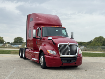 Truck cab exterior, red 2018 International LT625 sleeper, three-axle tractor with tall sleeper, chrome grille and headlights visible.