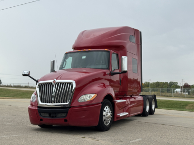 Truck cab and sleeper unit showing International LT625 with maroon paint and chrome grille
