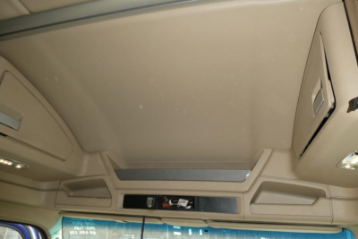 Cab interior view of a 2014 Kenworth T680 showing overhead storage compartments and sun visor area.