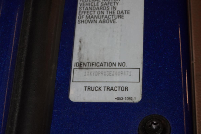Identification label on Kenworth truck showing VIN barcode area and 'Identification No.' field with VIN 1XKYDP9X3EJ409471 and 'TRUCK TRACTOR' text.