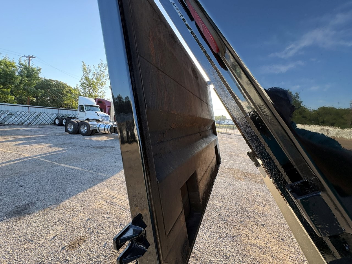Truck dump bed side view showing hydraulic lift and inner wall panels of the Mack GR84F dump truck.