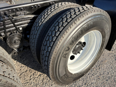 Truck axle and dual rear tires showing Michelin All Series tire with visible tread pattern and wheel hub