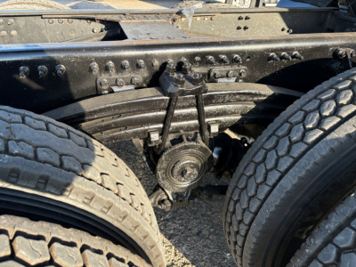Mack GR84F truck chassis showing rear axle suspension components and dual tires.