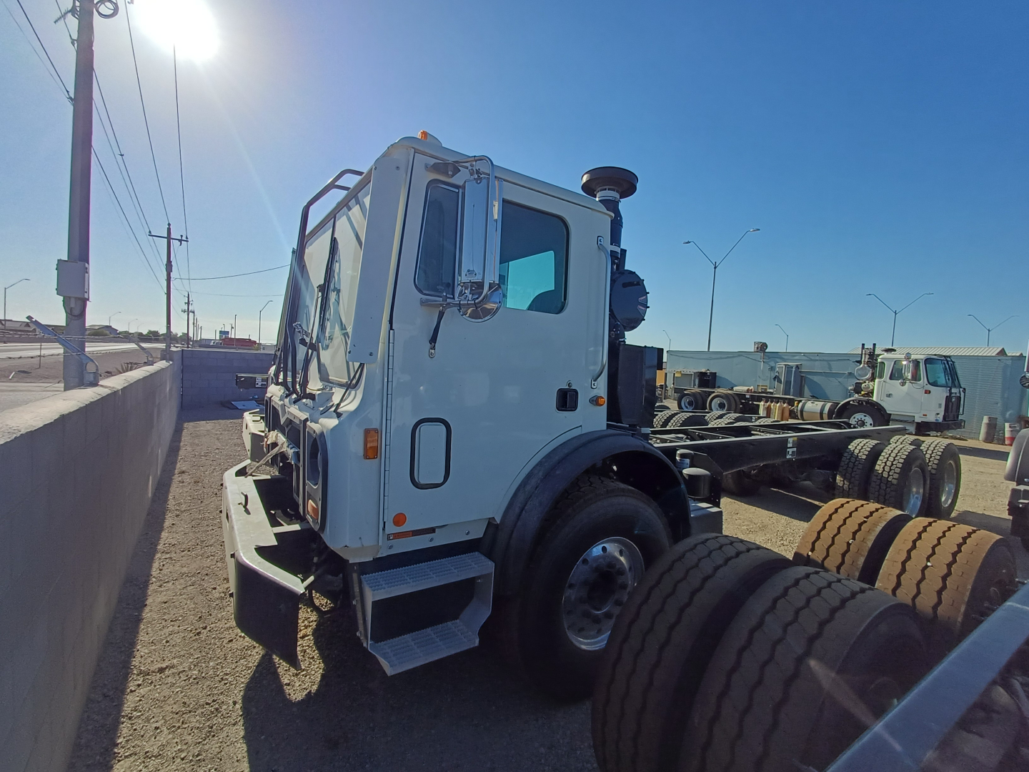 2026 Mack TE64E cab-side view showing front wheel, side mirror, and window; visible on the image are no legible labels or text.