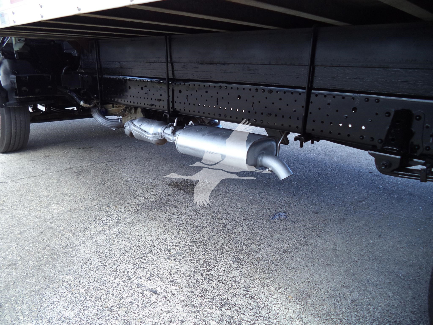 Isuzu NPRHD undercarriage showing exhaust muffler and pipe.