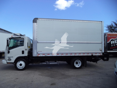 Box truck side view showing Isuzu NPR-HD with white cargo box and graphic logo on door side.