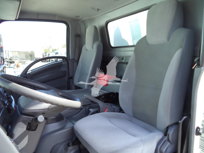 Isuzu NPR HD cab interior showing front seats and dashboard with steering wheel and center console.