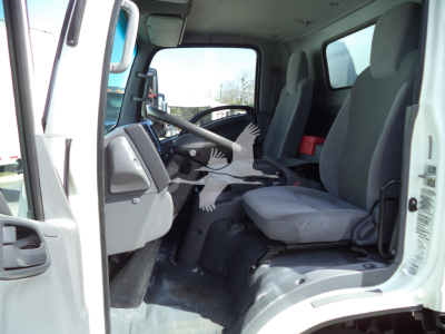 Isuzu NPR-HD truck cabin interior showing gray driver seat and dashboard from open doorway.