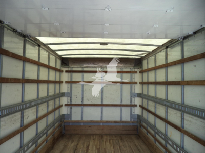 Truck cargo area interior with wooden side rails and metal wall framing. No text visible inside the box area.