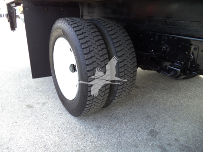 Isuzu NPR HD truck rear dual tires and undercarriage view in a box truck configuration.
