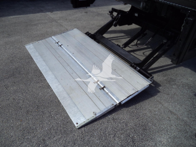 Isuzu NPR HD box truck tailgate platform with hydraulic lift in view.