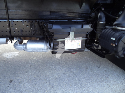 Underbody view of 2020 Isuzu NPR HD showing battery box, exhaust pipe, and chassis components.
