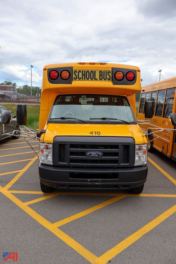 Ford E-Series school bus front view showing yellow body, black grille, and 'SCHOOL BUS' sign on top. Number '416' on the hood.