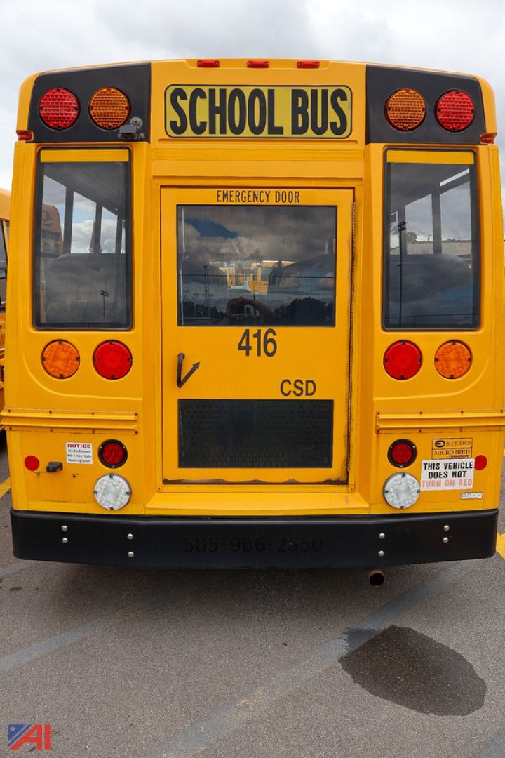 School bus rear view with yellow body and 'SCHOOL BUS' sign above emergency door, showing rear lights, vents, and numbers 416 CSD.