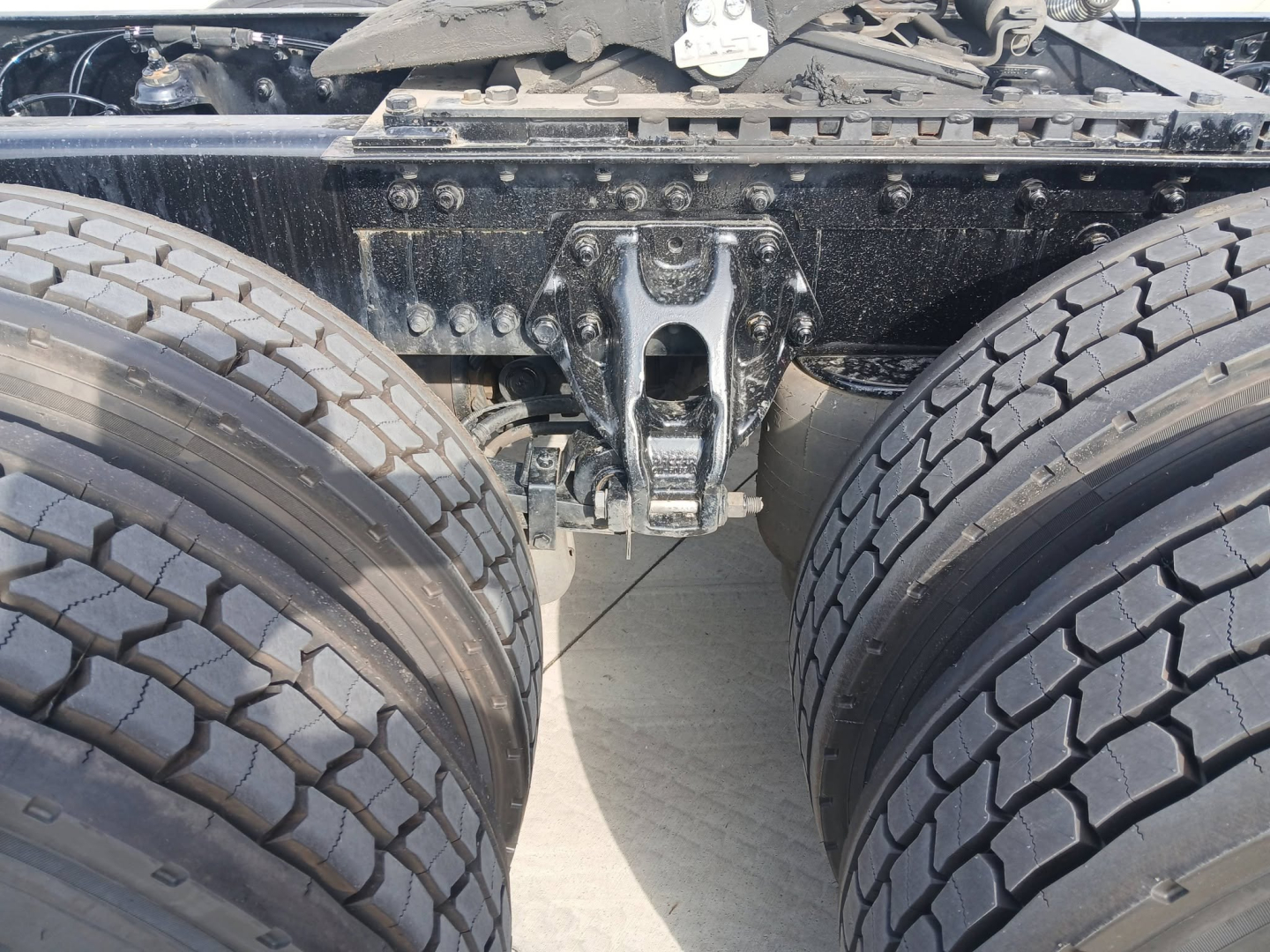Kenworth truck chassis with dual rear axles and fifth wheel mounting showing frame and suspension components.
