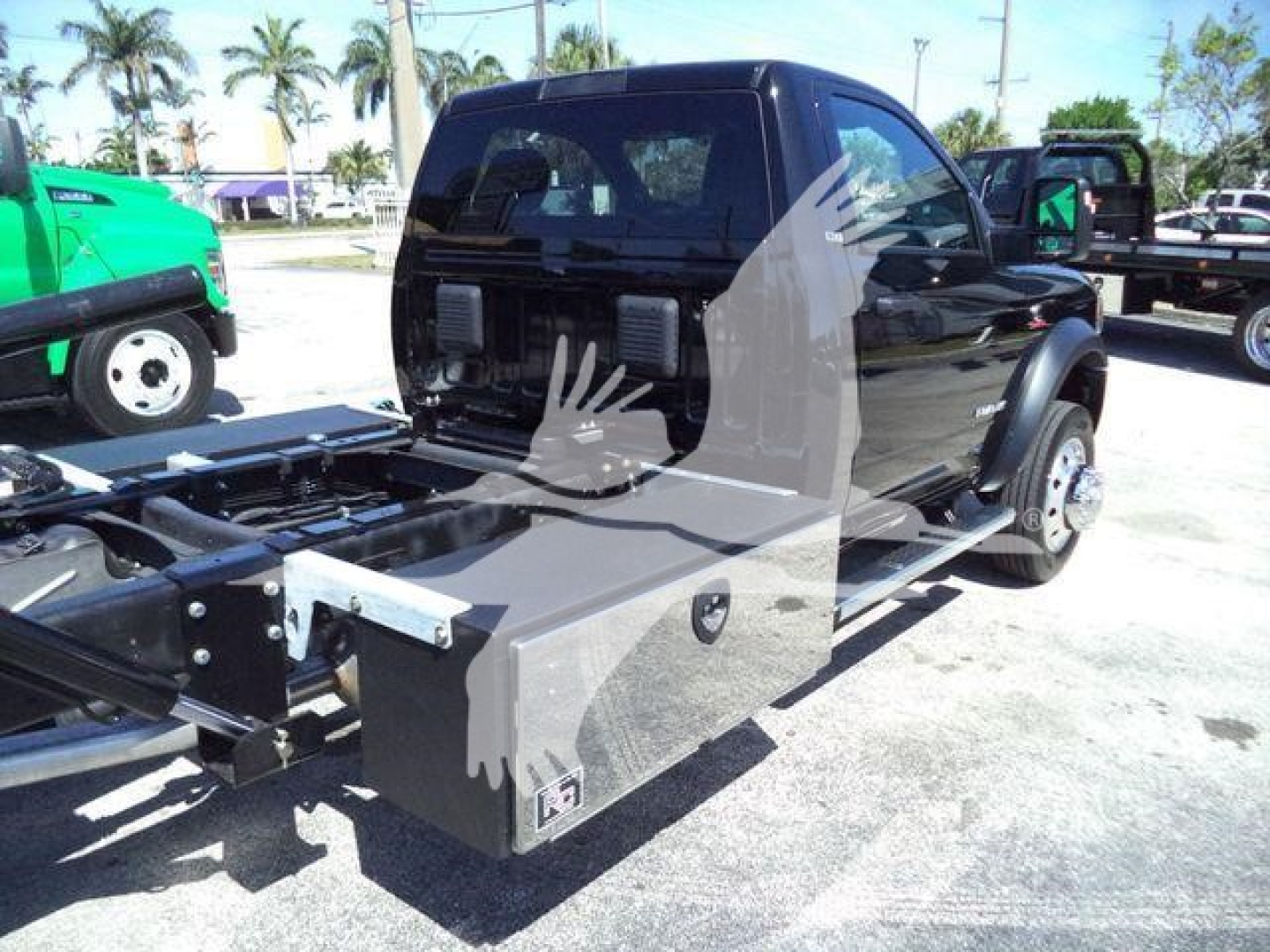Ram 5500 rollback truck cab with open chassis showing storage toolbox and truck bed area.