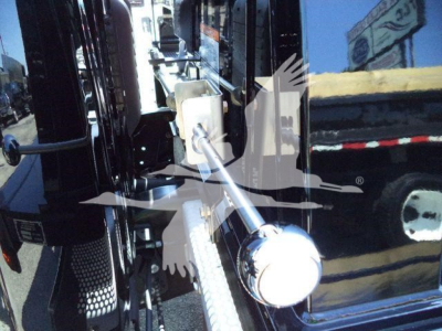 Ram 5500 rollback truck detail showing control lever and chrome ball knob near cab entrance.