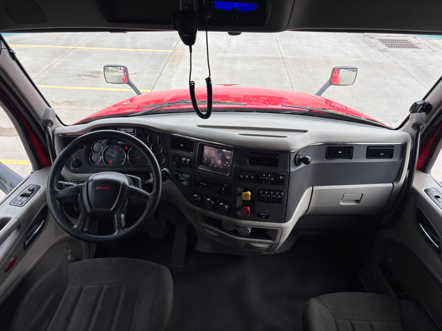 Peterbilt 579 cab interior showing steering wheel and dashboard with center touchscreen display.