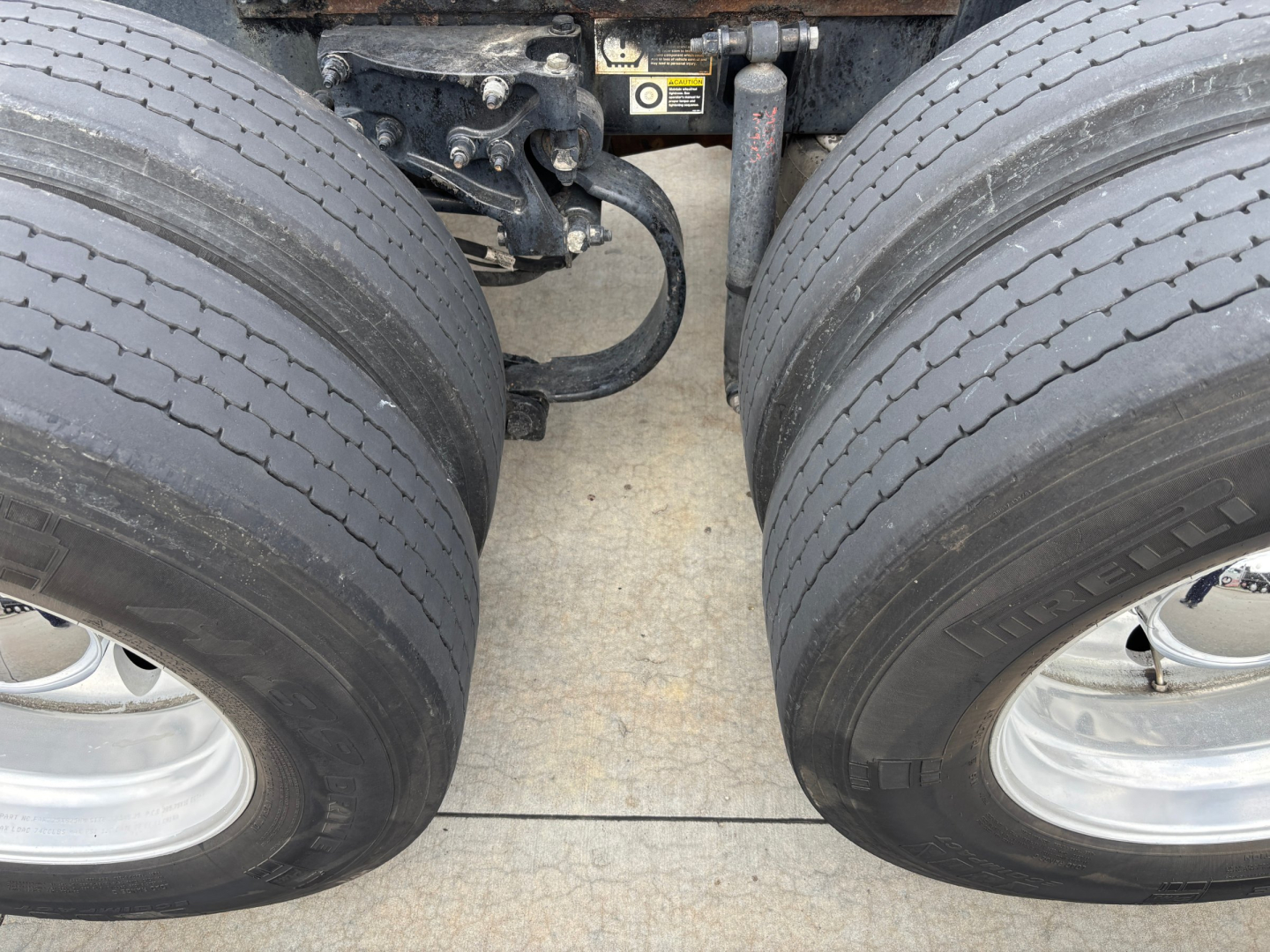 Peterbilt 579 dual rear wheels showing chassis and suspension components between tires.