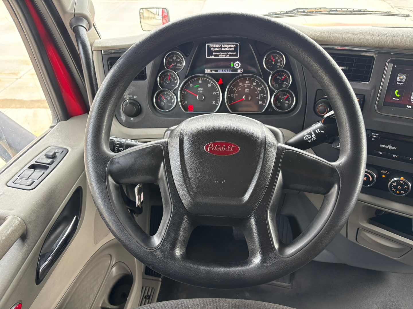 Peterbilt 579 truck interior showing steering wheel, dashboard gauges, and center console with controls.