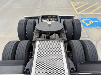 Peterbilt 579 chassis view showing rear dual axles with six wheels and aluminum access step, cabless sleeper configuration visible from above.