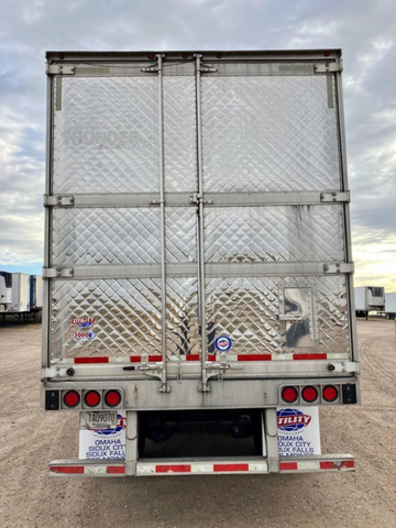 Rear view of a 2020 Utility Reefer trailer showing diamond plate doors, latches, and rear lights with reflective tape.