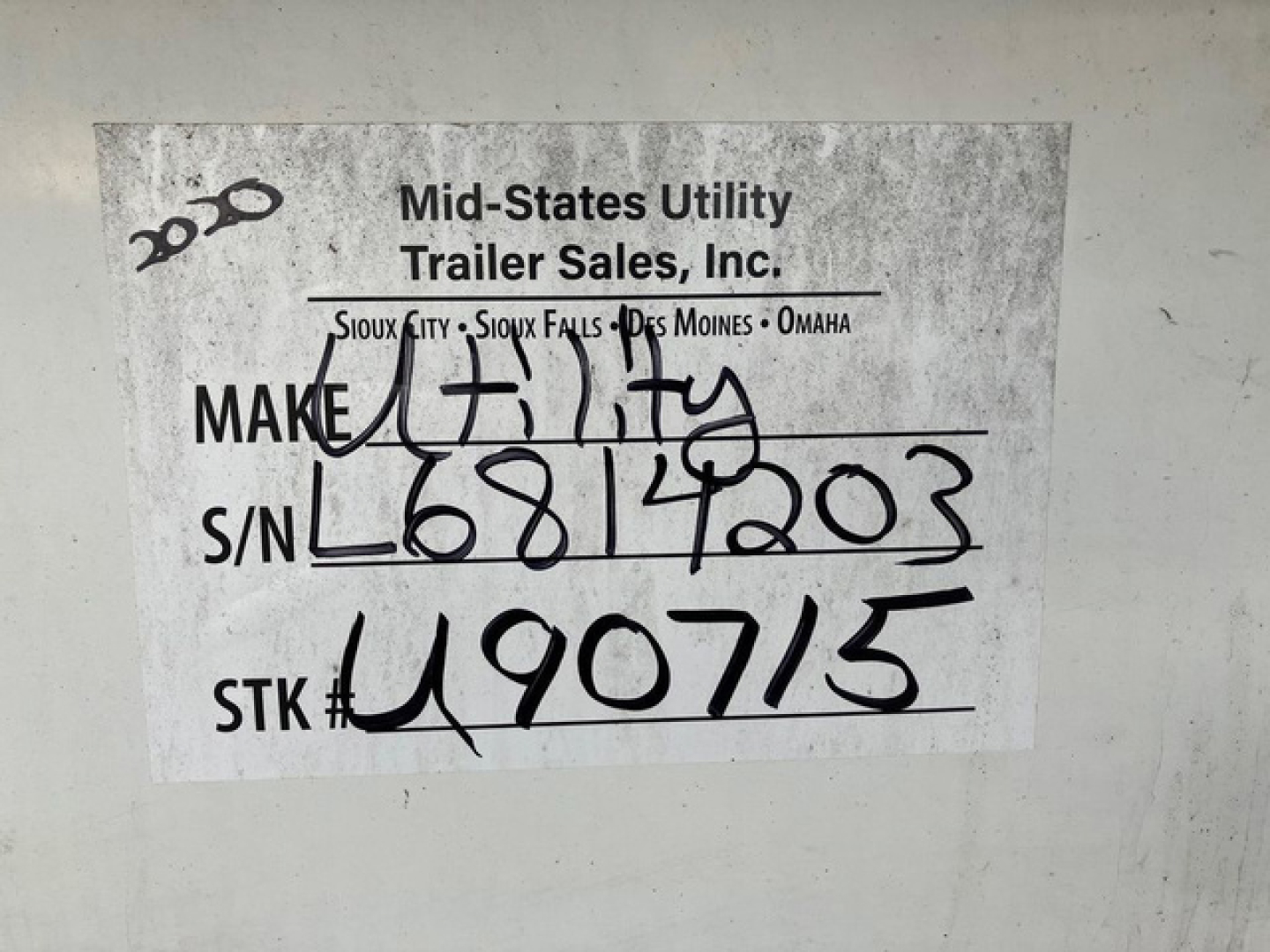 Label on trailer showing handwritten stock, serial, and make info. Reads: MAKE Utah? actually 'MAKE' followed by handwritten 'UTILITY' or 'FULTA'? S/N L6814203? S/N handwritten as L6814203. STK# 490715. Top text shows 'Mid-States Utility Tr