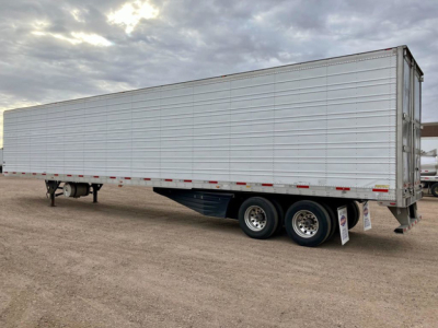 Trailer side view showing a 2020 Utility reefer trailer with tandem rear axles and aluminum siding