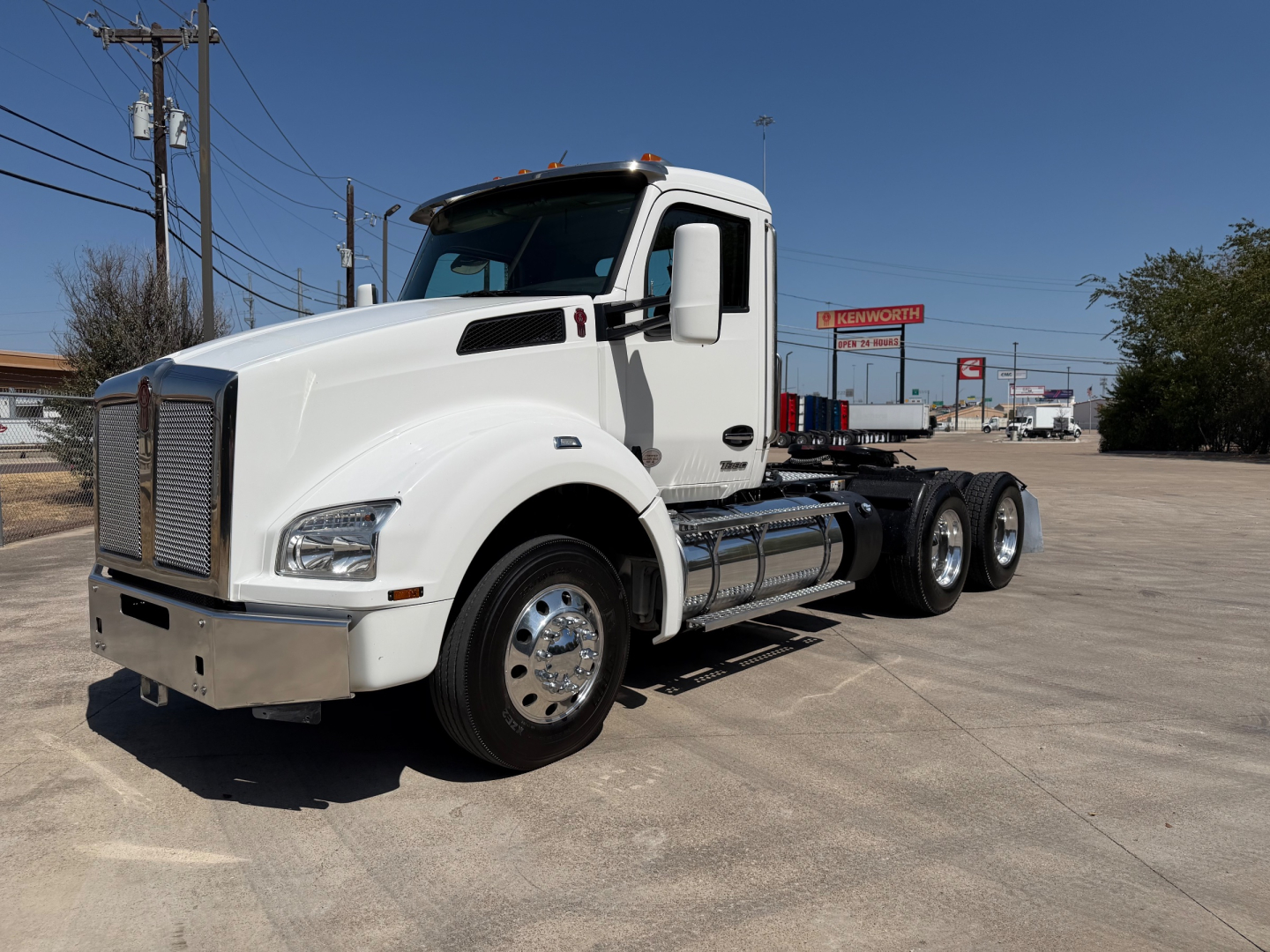 Kenworth T880 conventional daycab truck in white, side view showing cab, fuel tanks, step rails, and dual rear axles.