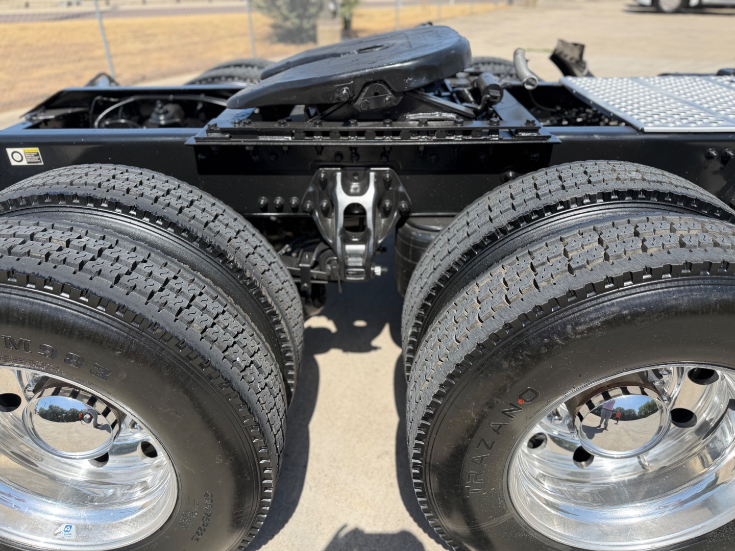 Kenworth T880 dual rear axles and chassis frame with wheels and tires visible, cab not in view.