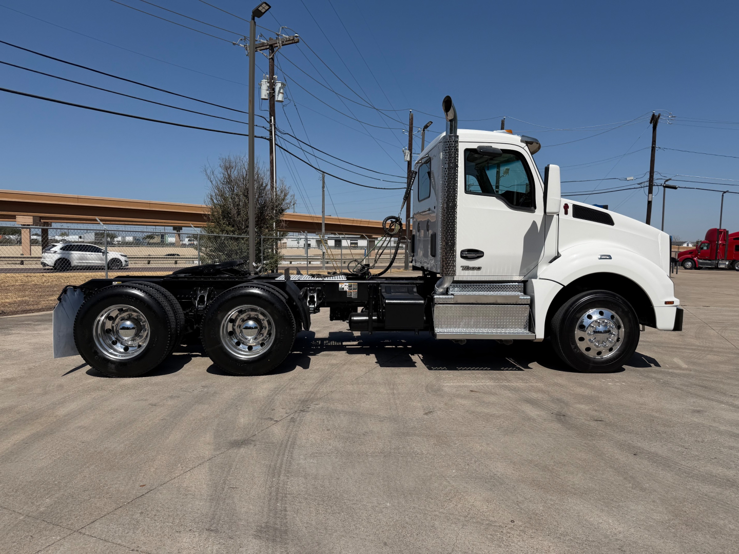 Kenworth T880 conventional cab truck side view showing chassis, sleeper cab, and front wheels.