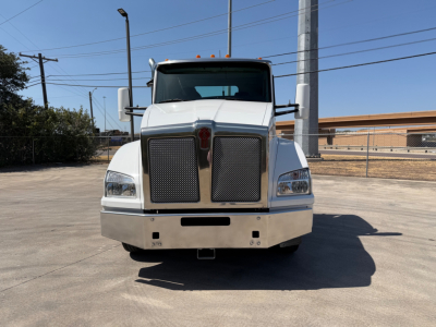 Kenworth T880 front view showing large grille, rectangular headlights, and bumper; white cab with stock number 0631422 visible; daytime outdoor lot.